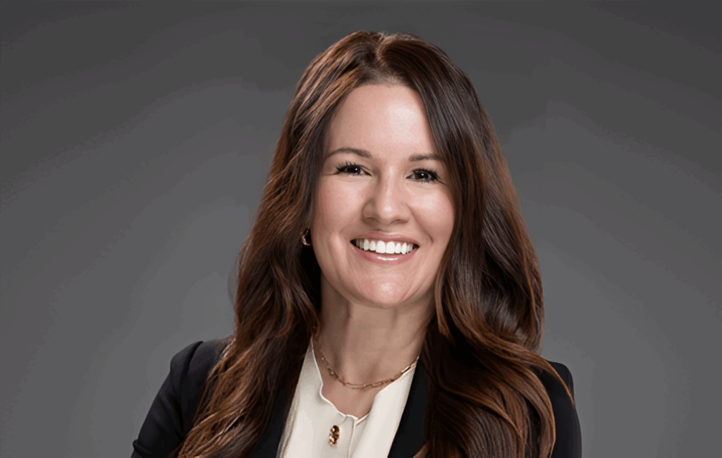 Smiling woman with long brown hair.
