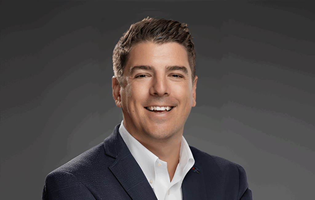 Smiling man in a suit and tie.