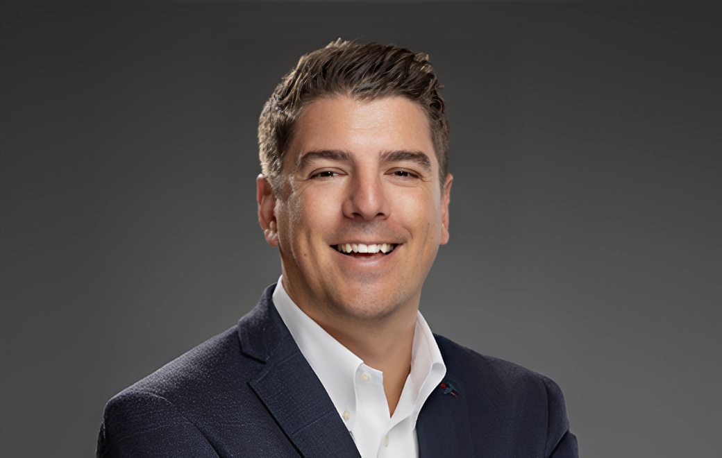Smiling man in a suit and tie.